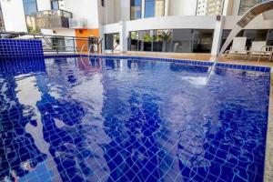 a large swimming pool with a water fountain at Sun Square Marista Vista Pça do Sol! Hospitais,mercados e cartórios, tudo perto! 301 in Goiânia