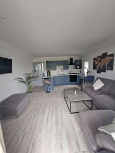 a living room with a couch and a table at Welcome to DC's Cottage in Holycross