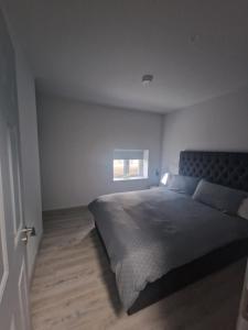 a bedroom with a large bed and a window at Welcome to DC's Cottage in Holycross