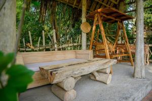 a wooden bench and a swing in a pavilion at Abing Dalem - Villa Durian in Tabanan