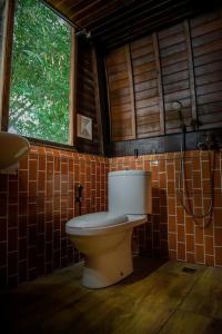 a bathroom with a toilet in a room at Abing Dalem - Villa Durian in Tabanan