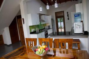 a bowl of fruit on a glass table in a kitchen at Koratuwa - Dickwella in Dickwella