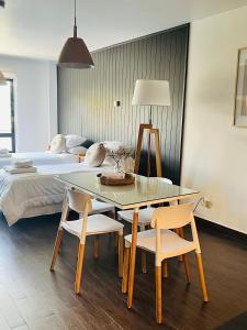 a bedroom with a table and chairs and a bed at Seaport Apartments STUDIO Rivadavia H in Ushuaia