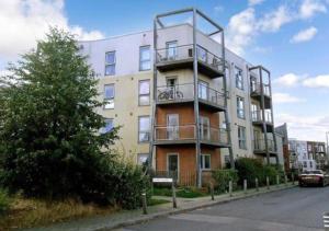 a tall building with balconies on the side of a street at The Dartford Lodge - Free Parking in Kent