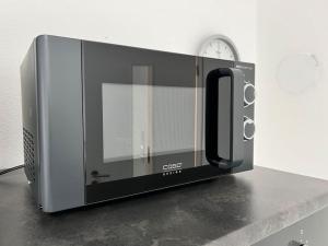 a microwave oven sitting on top of a counter at ganze Ferienwohnung 73m² in Wittlich in Wittlich