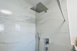 a bathroom with a shower with white marble walls at ganze Ferienwohnung 73m² in Wittlich in Wittlich