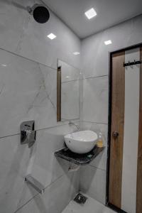 a bathroom with a white sink and a mirror at Hotel Paris inn in Ahmedabad