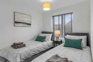 a bedroom with two beds and a window at 2 bedroom house NE Norwich in Norwich