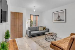 a living room with a couch and a table at 2 bedroom house NE Norwich in Norwich