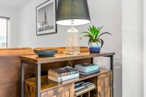 a table with a lamp and some books on it at 2 bedroom house NE Norwich in Norwich