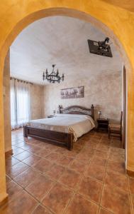 a bedroom with a large bed in a room at Casa Rural Castillo Diempures in Cantalojas