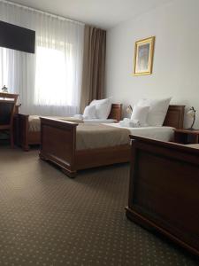 Łóżko lub łóżka w pokoju w obiekcie Hotel Constancja