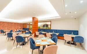 a restaurant with tables and chairs and a brick wall at Playotel Inn, Chandigarh in Zirakpur