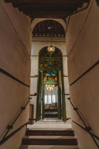 a hallway leading to a building with a stained glass window at Al Balad Hospitality in Jeddah
