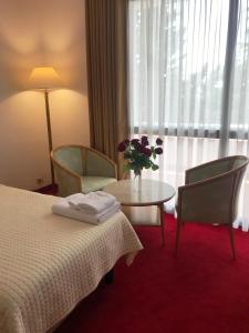 Postel nebo postele na pokoji v ubytování Chateau Linza Resort