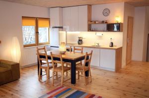 a kitchen and dining room with a table and chairs at Kaktus in Pasym