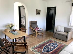 a living room with a table and a chair at Hotel Villa Tokur in Datca