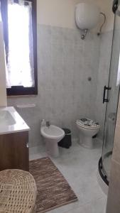 a bathroom with a sink and a toilet and a shower at Casa vacanza Maligio' Nebida Masua in Nebida