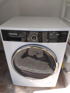 a white washing machine sitting in a room at Memorandului Residence in Timişoara