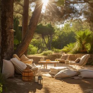 a patio with white furniture and a table and trees at LAVITA Camp - Capitana Villasimius in Capitana