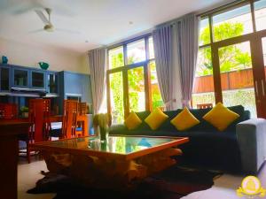 a living room with a couch and a coffee table at 3Bedroom Villa Kepiting Sanur in Sanur