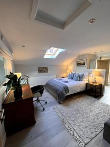 a bedroom with a bed and a desk and a window at The Old Lifeboat Station of Hoylake in Hoylake