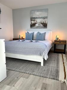 a bedroom with a large bed with blue pillows at The Old Lifeboat Station of Hoylake in Hoylake