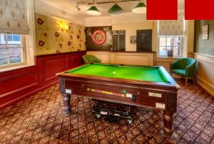 a billiard room with a pool table in it at The Bell Hotel in Burgh le Marsh