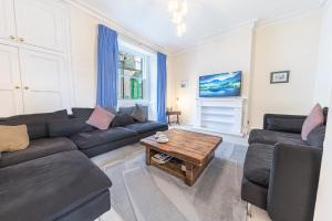 a living room with a couch and a coffee table at Town centre property convenient for the fells in Keswick