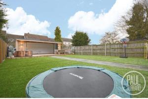 a backyard with a trampoline in the grass at Immaculate 3-Bed House in Bungay in Bungay