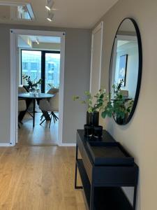 uma sala de estar com um espelho e uma mesa em TheNorthernExplorer Penthouse em Tromsø