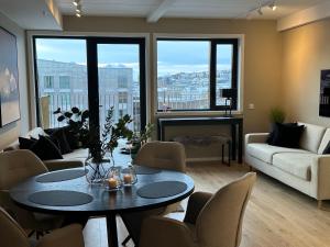 a living room with a table and chairs at TheNorthernExplorer Penthouse in Tromsø
