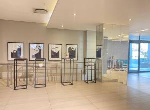 a room with a table and some pictures on the wall at Love Luxe @ Sandton skye in Johannesburg +26 photos