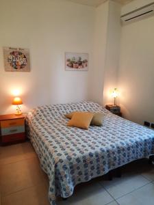 a bedroom with a bed with two pillows on it at B&B Costa Gentile in Taranto