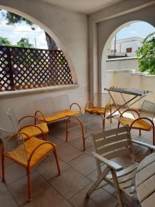 a group of chairs and tables on a balcony at B&B Costa Gentile in Taranto