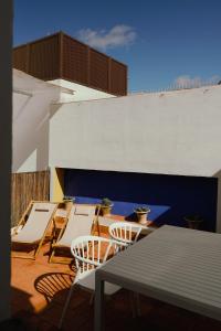 un grupo de sillas y mesas en un patio en Casa Miguel - Apartamento 4, en Sanlúcar de Barrameda