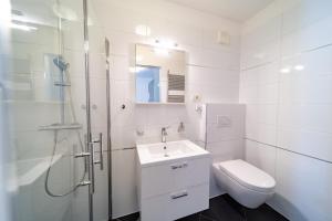 a bathroom with a sink and a shower and a toilet at Spacious modern One bedroom Apartment with Garden & SeaView in Rab +20 photos
