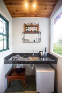 a kitchen with a sink and a counter top at Catavento Pousada in Alto Paraíso de Goiás
