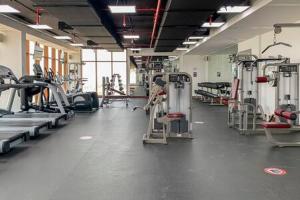 a gym with several treadmills and machines at Frank Porter - Palm Views West in Dubai