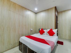 a bedroom with a large bed with red pillows at Super OYO Flagship Hotel Diamond in Mumbai