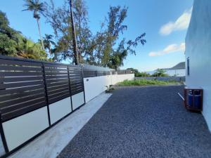 a fence on the side of a building at Ashan Luxury Seafront Villa 1 in Grande Rivière Sud Est
