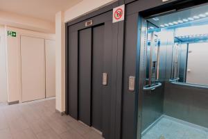 an elevator in a building with a glass door at Pierre & Vacances La Merceria in El Tarter +16 photos