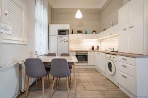 a kitchen with a table and chairs in it at BpR Castle Hill Apartment with Garden in Budapest
