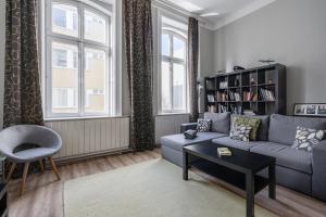 a living room with a couch and a book shelf at BpR Castle Hill Apartment with Garden in Budapest