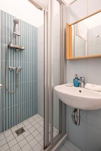 a bathroom with a sink and a shower at BpR Castle Hill Apartment with Garden in Budapest