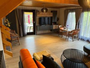 a living room with a couch and a table at Ferienhaus 32 in Kinding