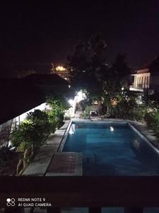 a swimming pool at night with a view at Spacious Room Jimbaran in Jimbaran