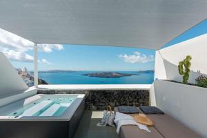 a view of the ocean from the balcony of a house at Luxurious Santorini Masionette Villa - 1 Bedroom - Astounding Caldera Sea Views and Private Outdoor Hot Tub - Fira in Fira