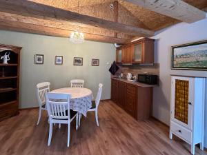 a kitchen with a table and chairs in a room at A1 apartments with free parking in Rīga