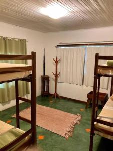 a room with two bunk beds and a window at Catavento Pousada in Alto Paraíso de Goiás
